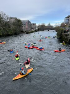 several colourful kayaks in river